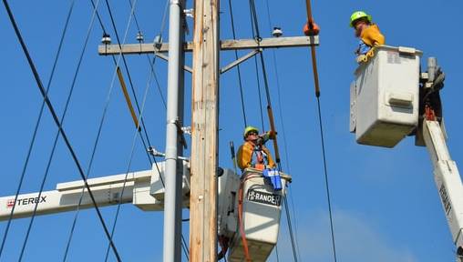Two Line Workers in Cherry Pickers