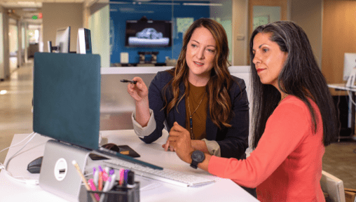 Business Assistant and Boss at a desk