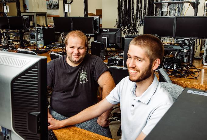 two students work together at a computer