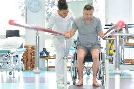 Physical therapy assistant helping man in wheelchair